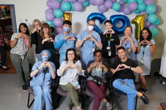 Members of MGH’s Long Stay Critical Care Care Team make hearts with their hands.