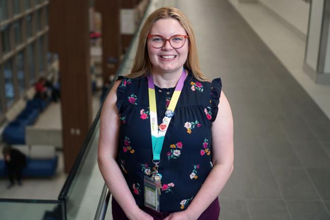 Kristen Currie smiling and standing in a hallway at Michael Garron Hospital.