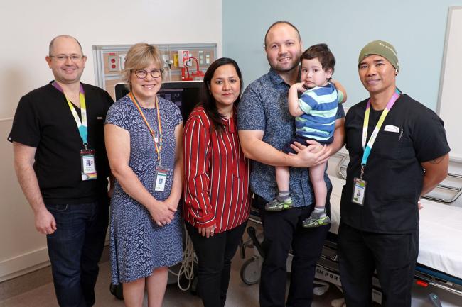 A group of people standing inside an ultrasound room.