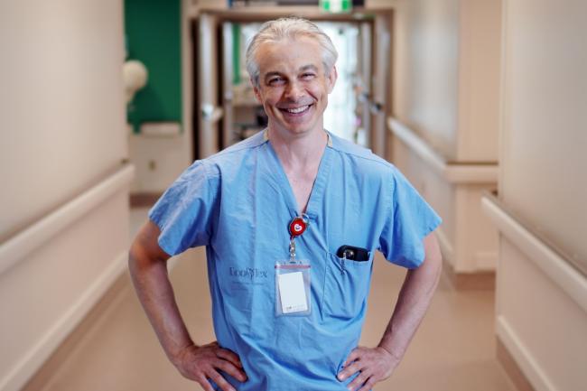 Dr. Jeff Powis smiling and standing in a hallway at MGH.