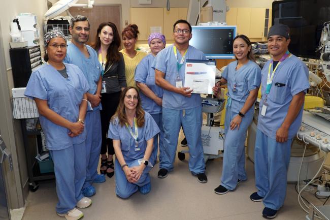 Members of the Cardiac Catheterization Laboratory Team standing together inside a procedure room at Michael Garron Hospital.