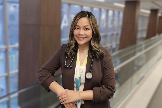Raychel standing and smiling in MGH hallway. 