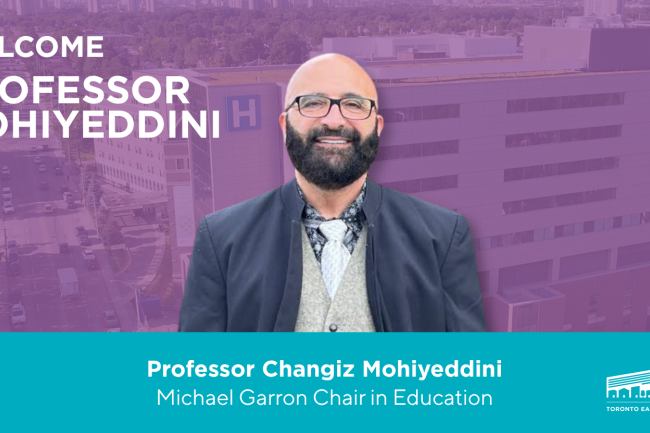 Professor Changiz Mohiyeddini, wearing a blazer and glasses, smiles at the camera. 