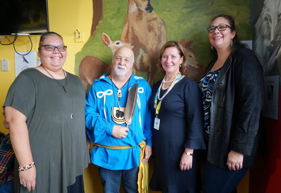 Elder Little Brown Bear with Sarah Downey and community members People gathered in MGH paediatric healing room