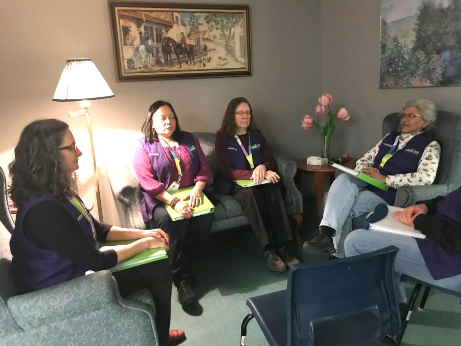 Comfort Choir meditating before performing for palliative care patients at Michael Garron hospital.