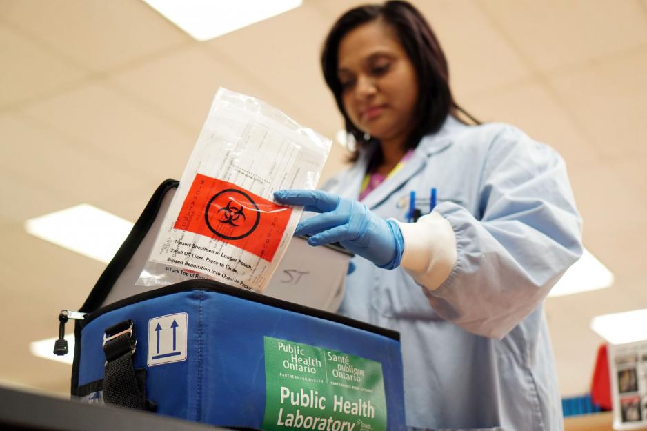 Lab technician packaging a specimen to be sent to Public Health Ontario for COVID-19 testing.