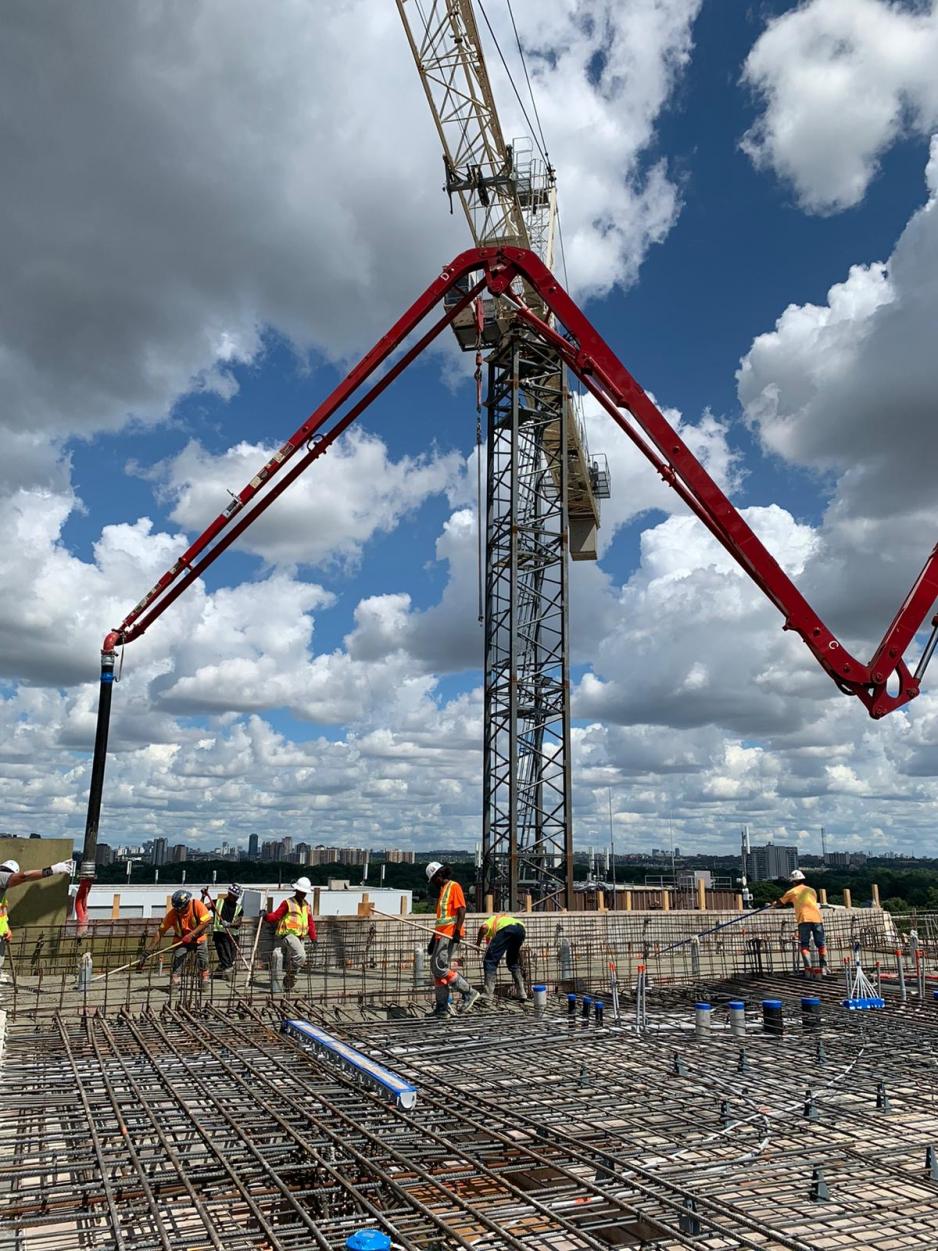 Large placing boom positioning concrete for final concrete slab pour