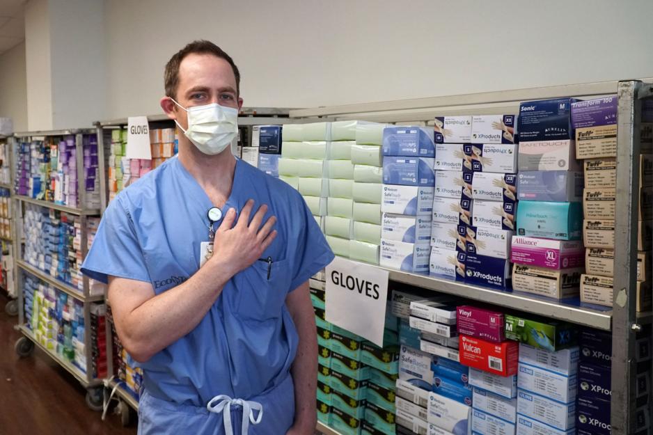 Dr. Michael Warner stands alongside boxes of donated PPE.