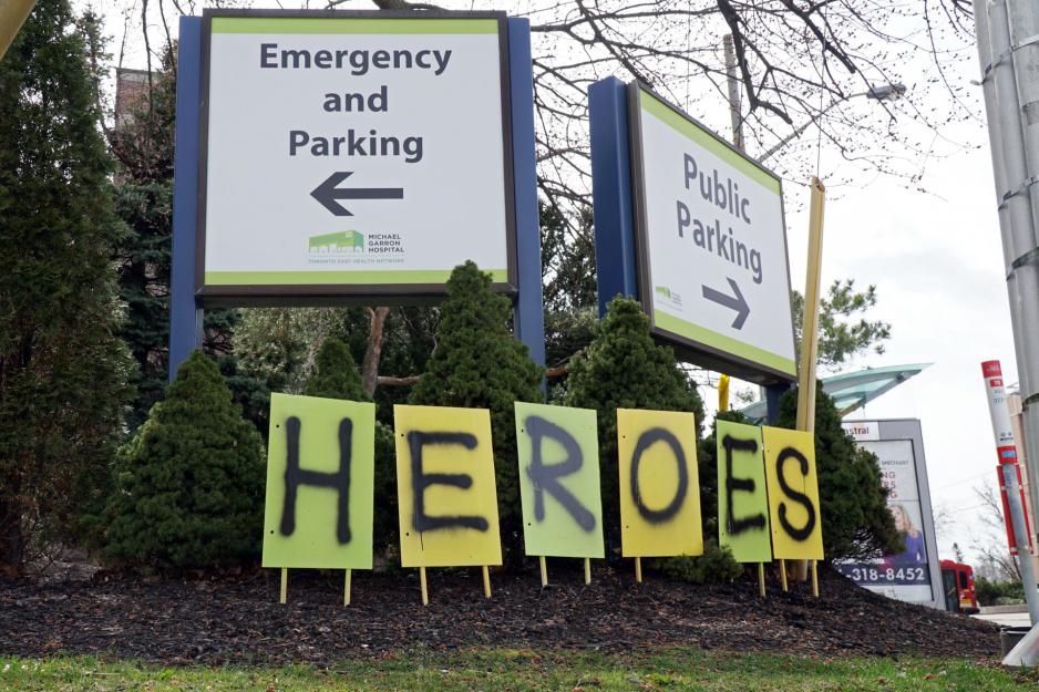 Signs spelling out the word HEROES are displayed outside MGH.