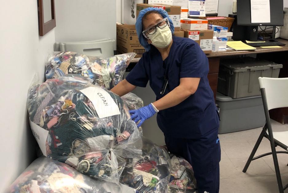 A nurse at MGH collects donated masks as part of our mask drive.