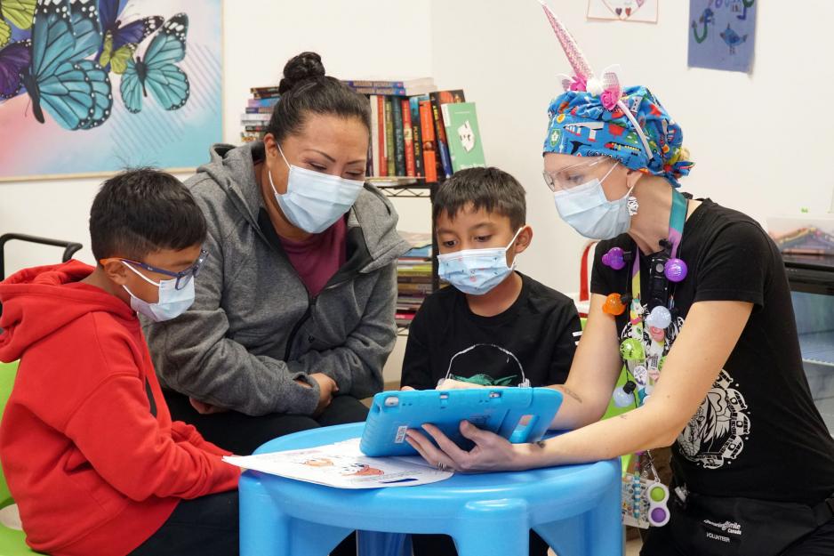 A family waits to receive care in the dedicated waiting area of the MGH's Child and Youth Emergency Zone.