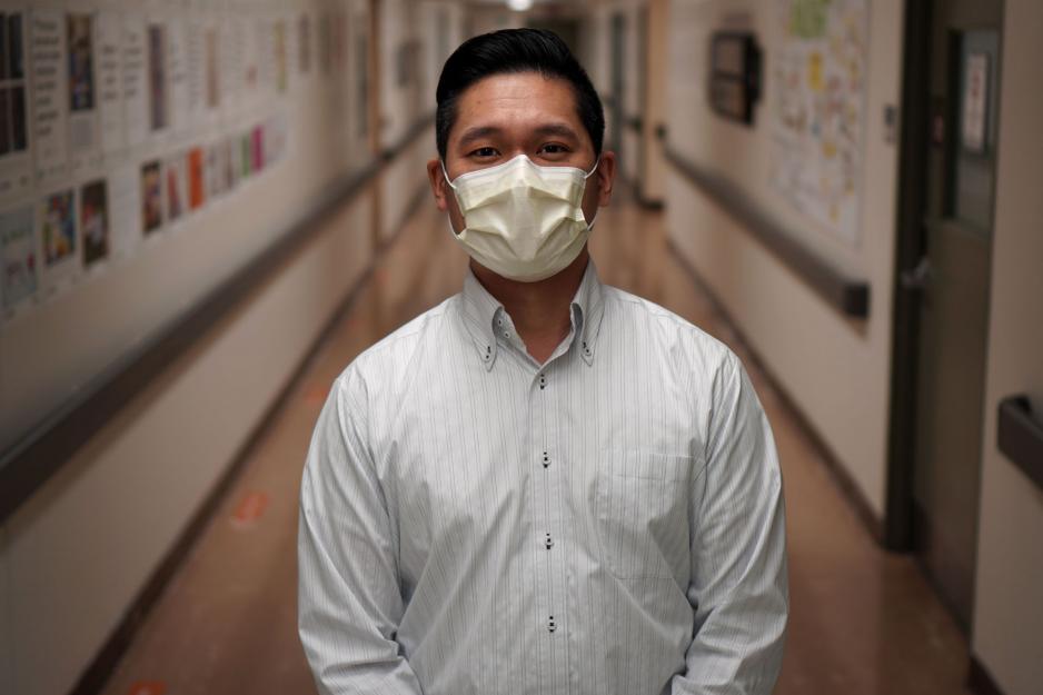 Andrew Liu, director of pharmacy services, stands in a hallway