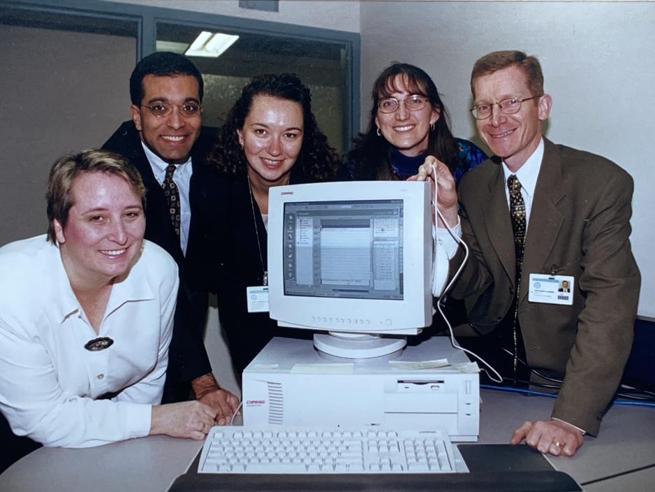 Wolf Klassen gathered around a computer with colleagues at MGH.