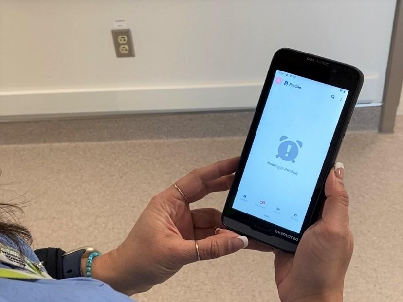 A nurse holds a mobile device at Michael Garron Hospital
