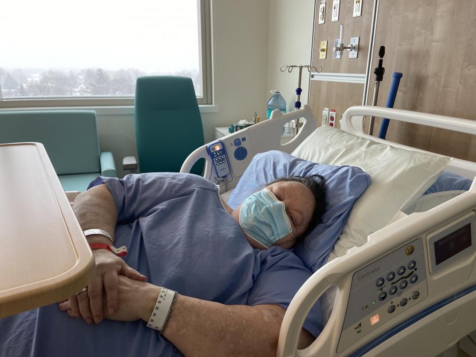 Caron Carter, a patient at MGH, rests in her bed in her new patient room in the Ken and Marilyn Thomson Patient Care Centre