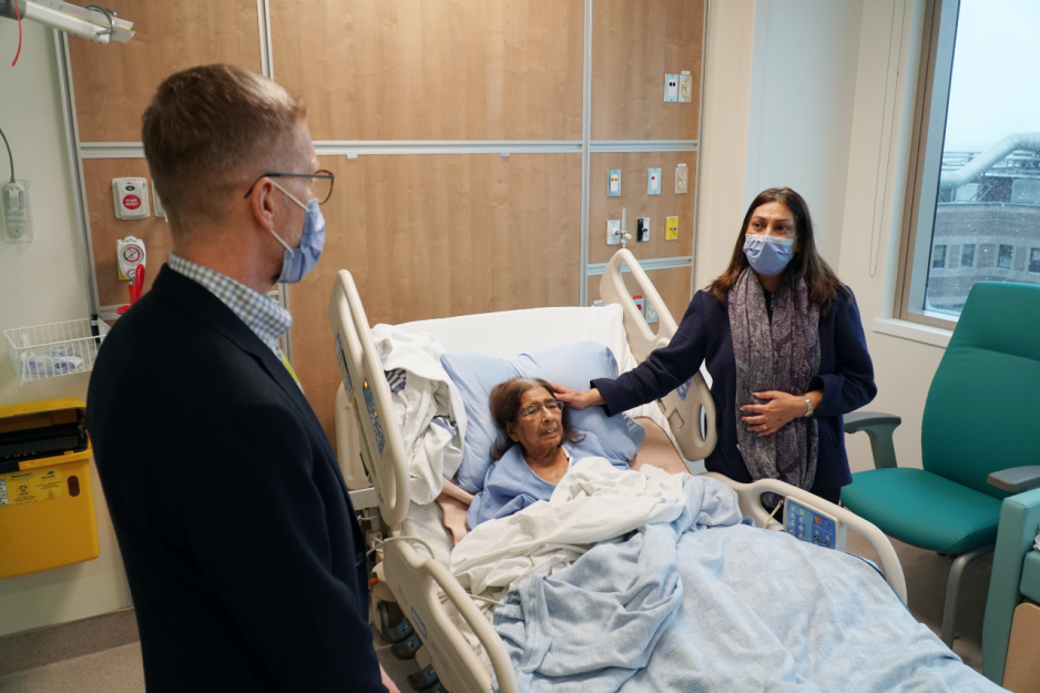 Wolf Klassen, President and CEO, Interim, of Michael Garron Hospital, welcomes Remti Virani into her new room in the Ken and Marilyn Thomson Patient Care Centre with her daughter Shirin Dhanani. 