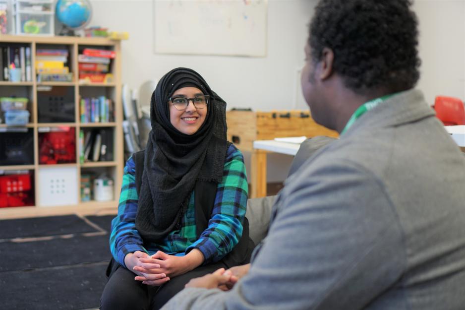 A young woman sitting beside a mental health counsellor.