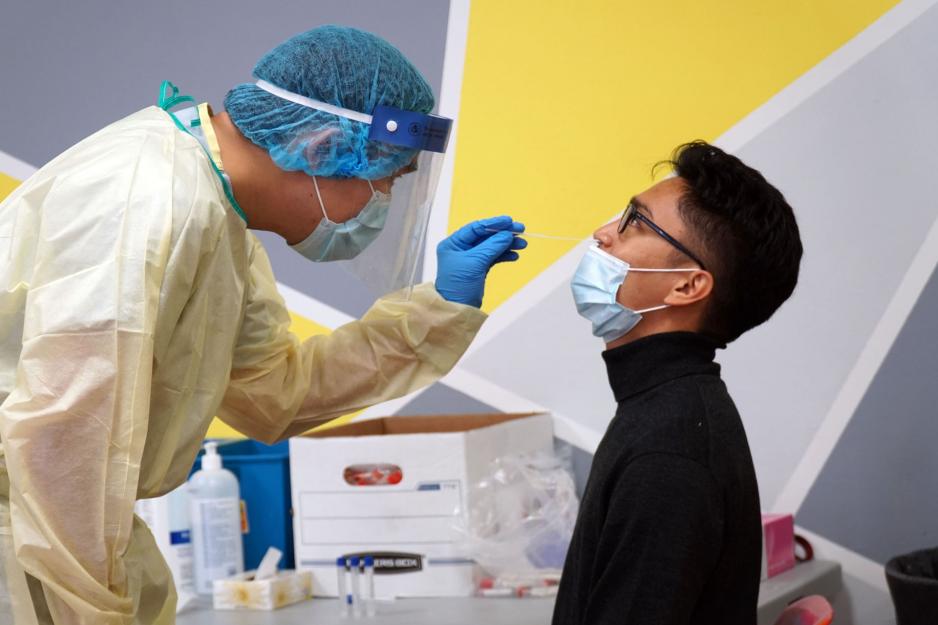 A healthcare provider administers a COVID-19 PCR test in Thorncliffe Park.