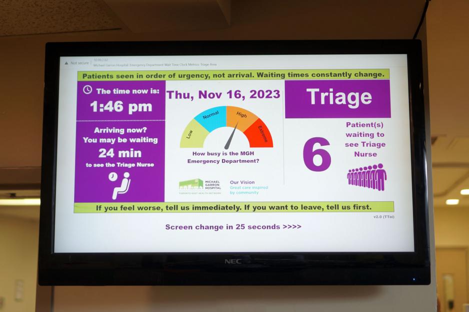 A screen displays estimated wait times and how busy the Emergency Department is.