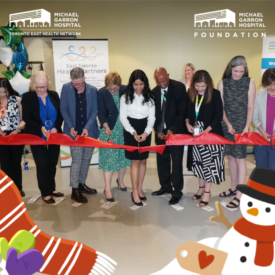 A joyful group of people cutting a red ribbon