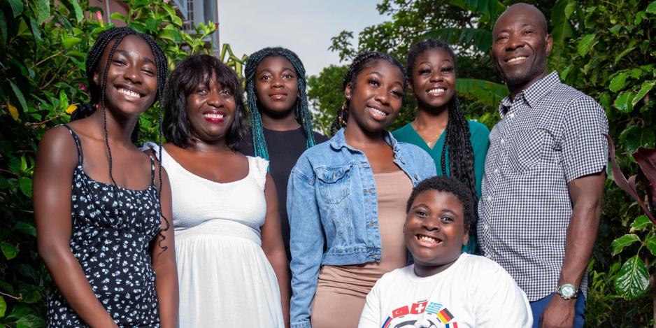 Anthea Charles poses with her family including 15-year-old Idika Theodore Njoku.