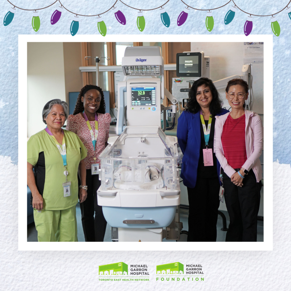 Four healthcare providers standing around an incubator at a hospital.