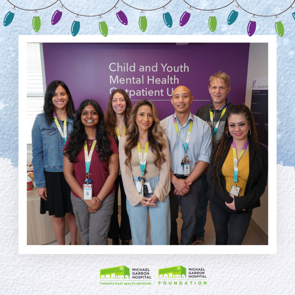 A group of healthcare workers standing in front of a sign that reads Child and Youth Mental Health Outpatient Unit