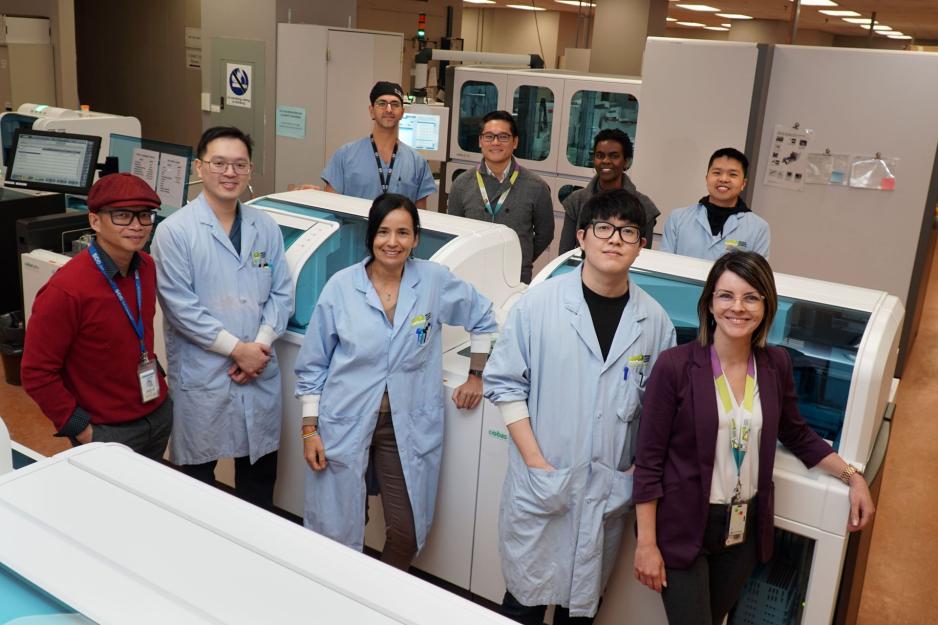 A group of healthcare professionals standing inside a hospital lab.