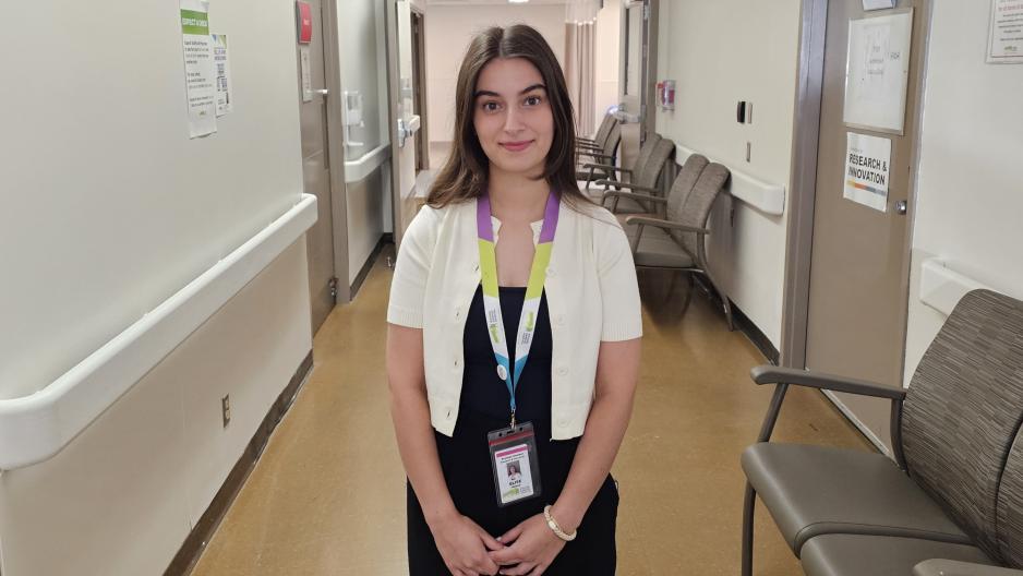 Person standing in a hospital hallway.
