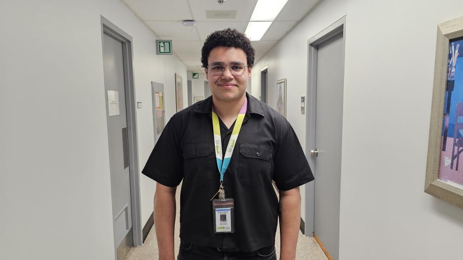 Person standing in a hospital hallway. 
