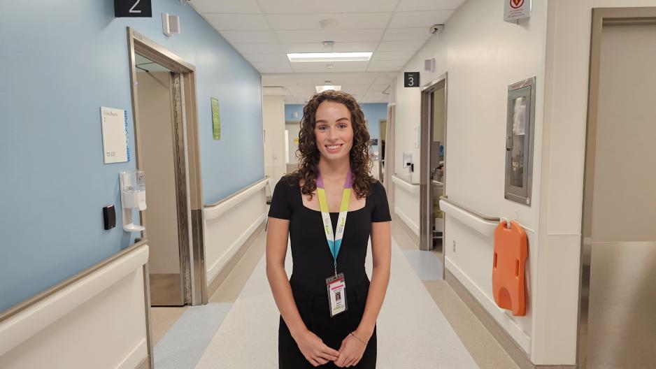Person standing in a hospital hallway. 