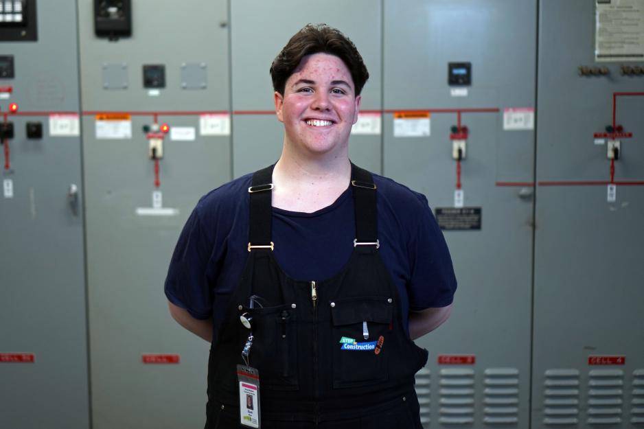 Person standing and smiling. 