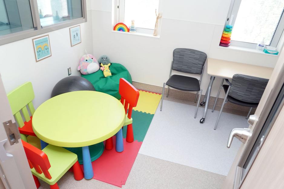 A colourful room with a table and chairs for children.